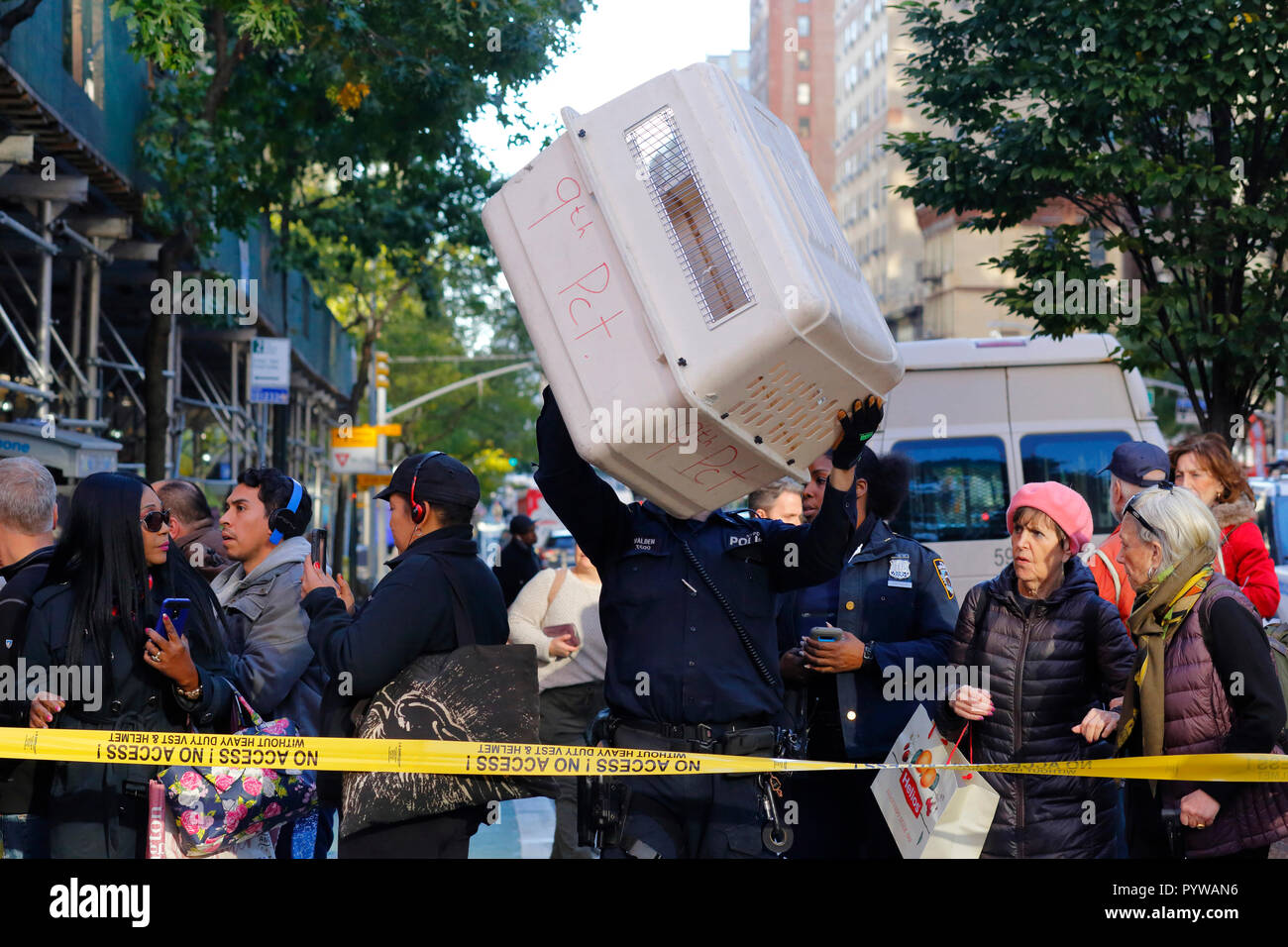New York City, USA. 30 Okt, 2018. Notdienste Polizei Ansatz die Szene mit einem großen Tier Käfig auf Darlehen aus dem 9 Polizeidirektion im East Village von Manhattan, ein Bereich mit einem großen Red tailed hawk Bevölkerung. Stockfoto