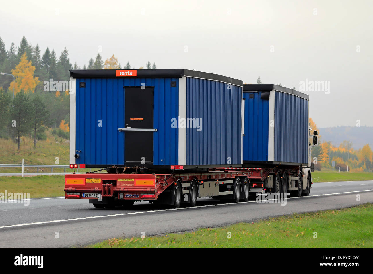 Salo, Finnland - 12. Oktober 2018: Zwei tragbare Kabinen auf LKW-Anhänger an der Autobahn mit Lastwagen transportiert an einem nebligen Tag im Herbst. Stockfoto
