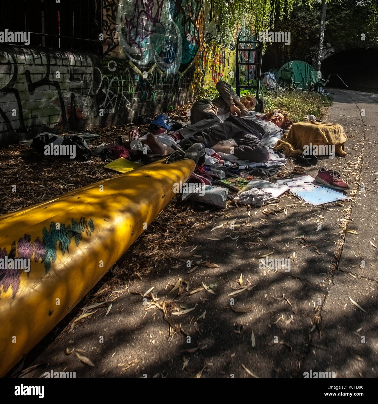 Eine obdachlose Paar schlafen von Regents Canal neben einem Kanu Stockfoto