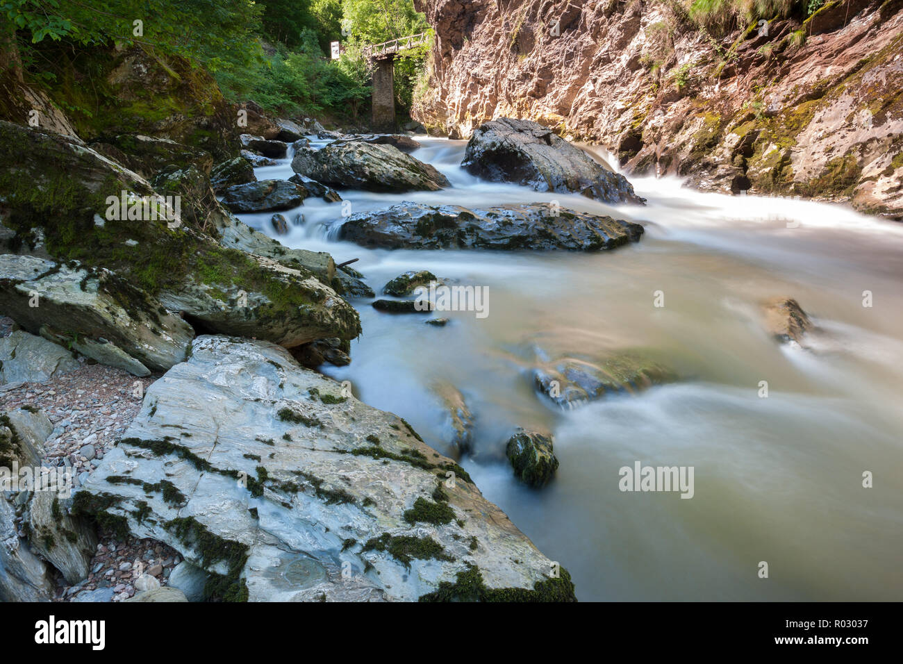 Schnell fließenden Fluss und hige Felsbrocken mit einer langen Verschlusszeit Stockfoto
