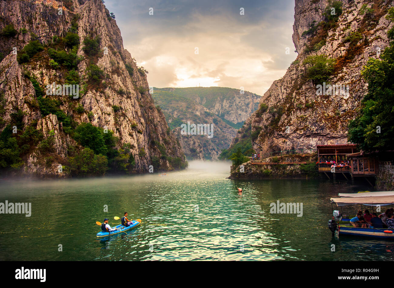 Matka, Mazedonien - 26. August 2018: Canyon Matka in der Nähe von Skopje, mit Menschen, Kajakfahren und magische neblige Landschaft mit ruhigen Wasser Stockfoto