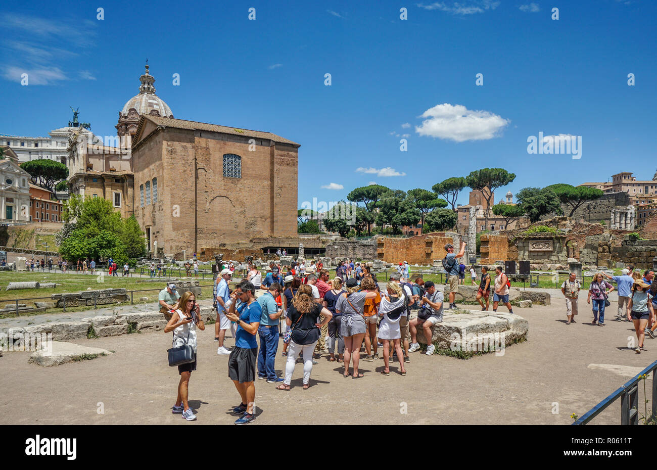 Eine touristische Gruppe am Forum Romanum vor dem Hintergrund der Curia Julia, ein Senat Haus im alten Rom Stockfoto