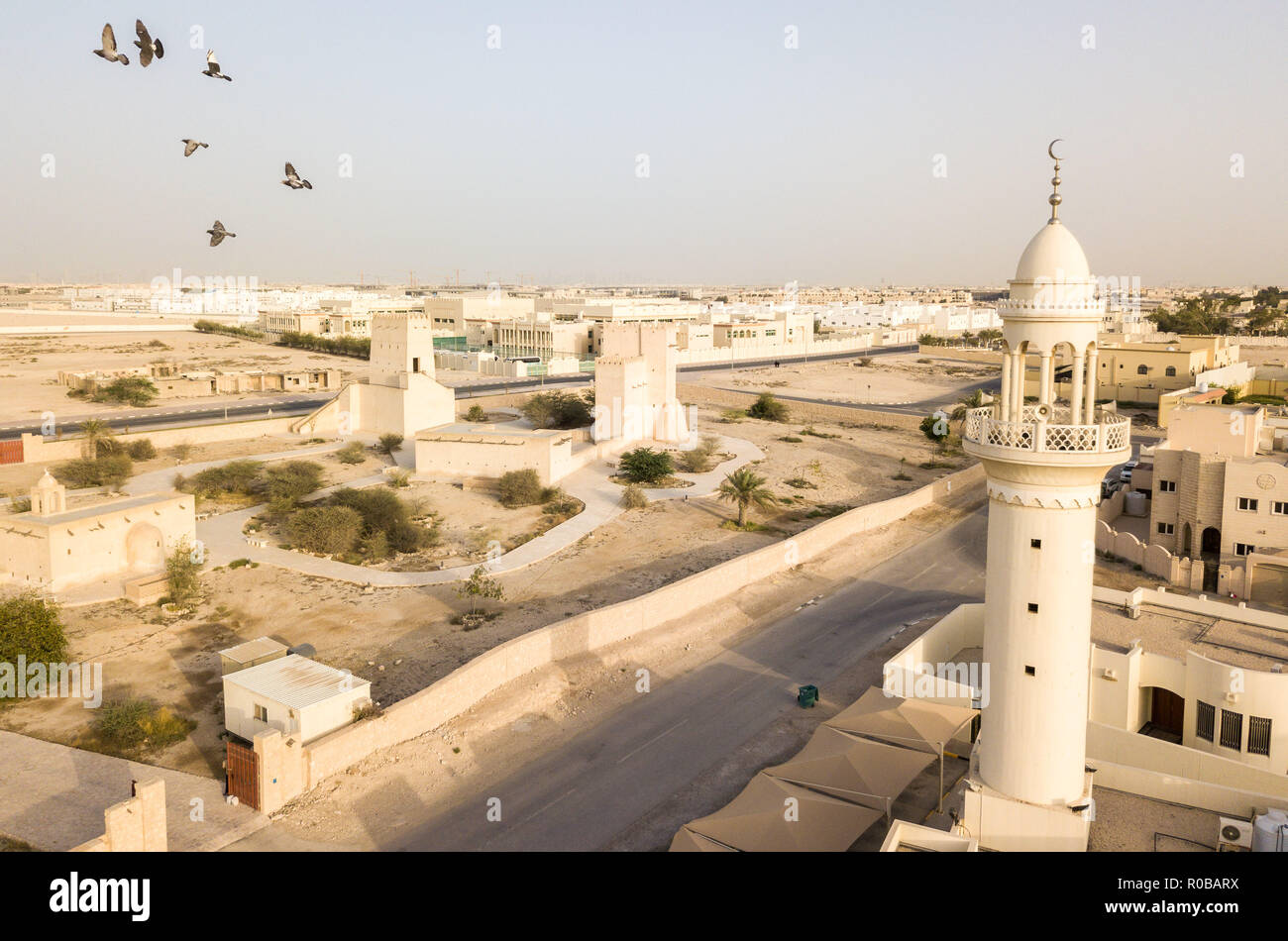 Barzan Wachtürme und eine Moschee. Alte arabische Festung. Fort Türmen. Antenne drone Foto mit Vögeln aus traditionellen und modernen arabischen Stadt, Katar Stockfoto