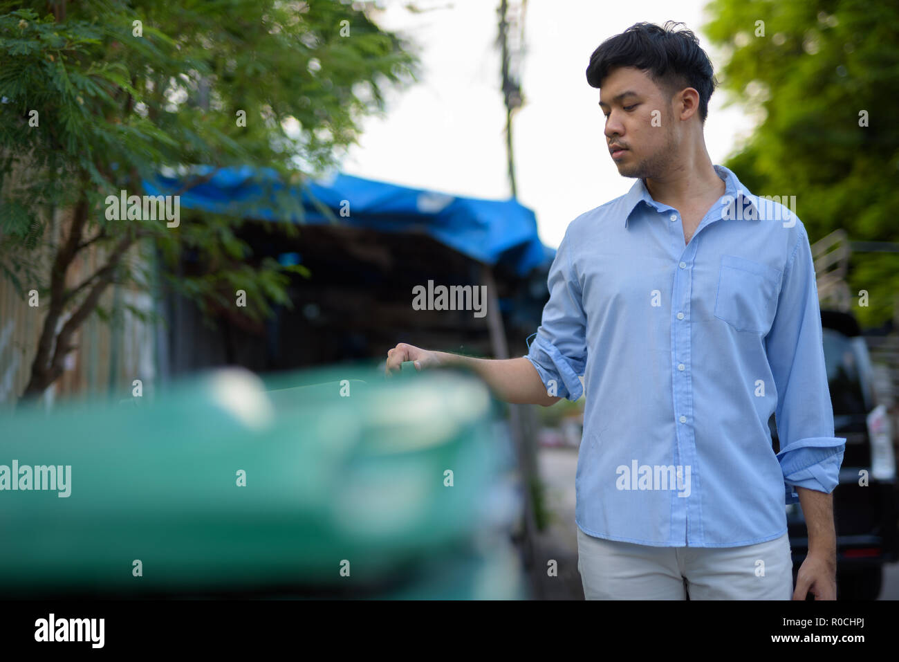 Junge asiatische Geschäftsmann Kontrolle der Müll in den Straßen außend Stockfoto