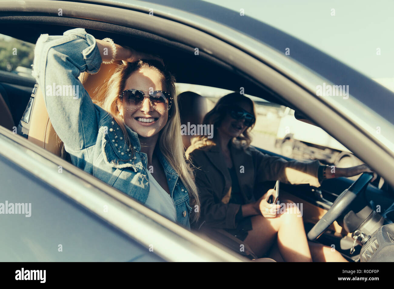 Getönten Foto von Seite der glücklichen Frauen im Auto sitzen Stockfoto