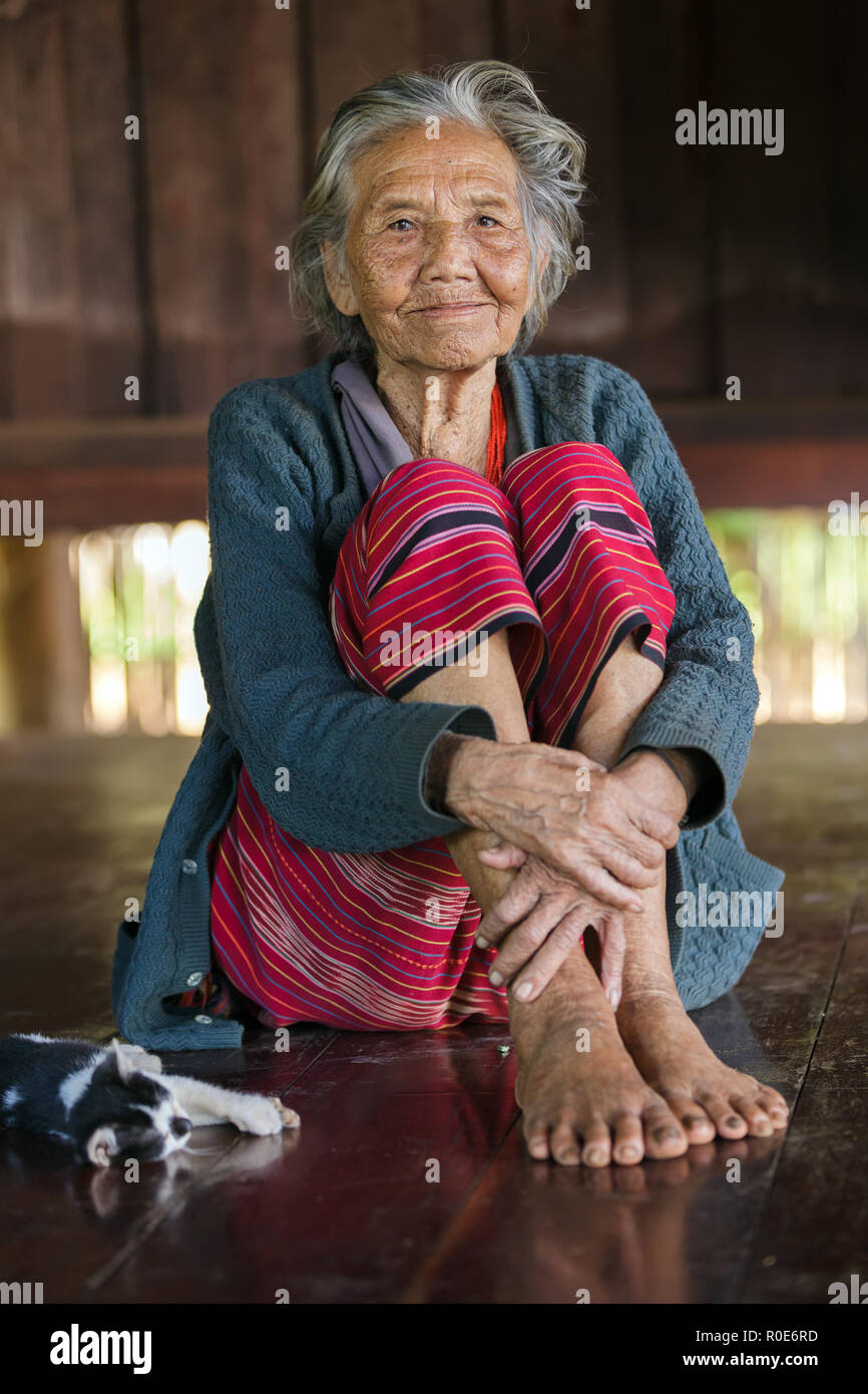 BAM MUANG PAM, Thailand, 22. November: Eine ältere Frau Karen, Thai Ethnizität, posiert in ihrem Holzhaus, Ihre Katze neben Lügen, in der Villa Stockfoto