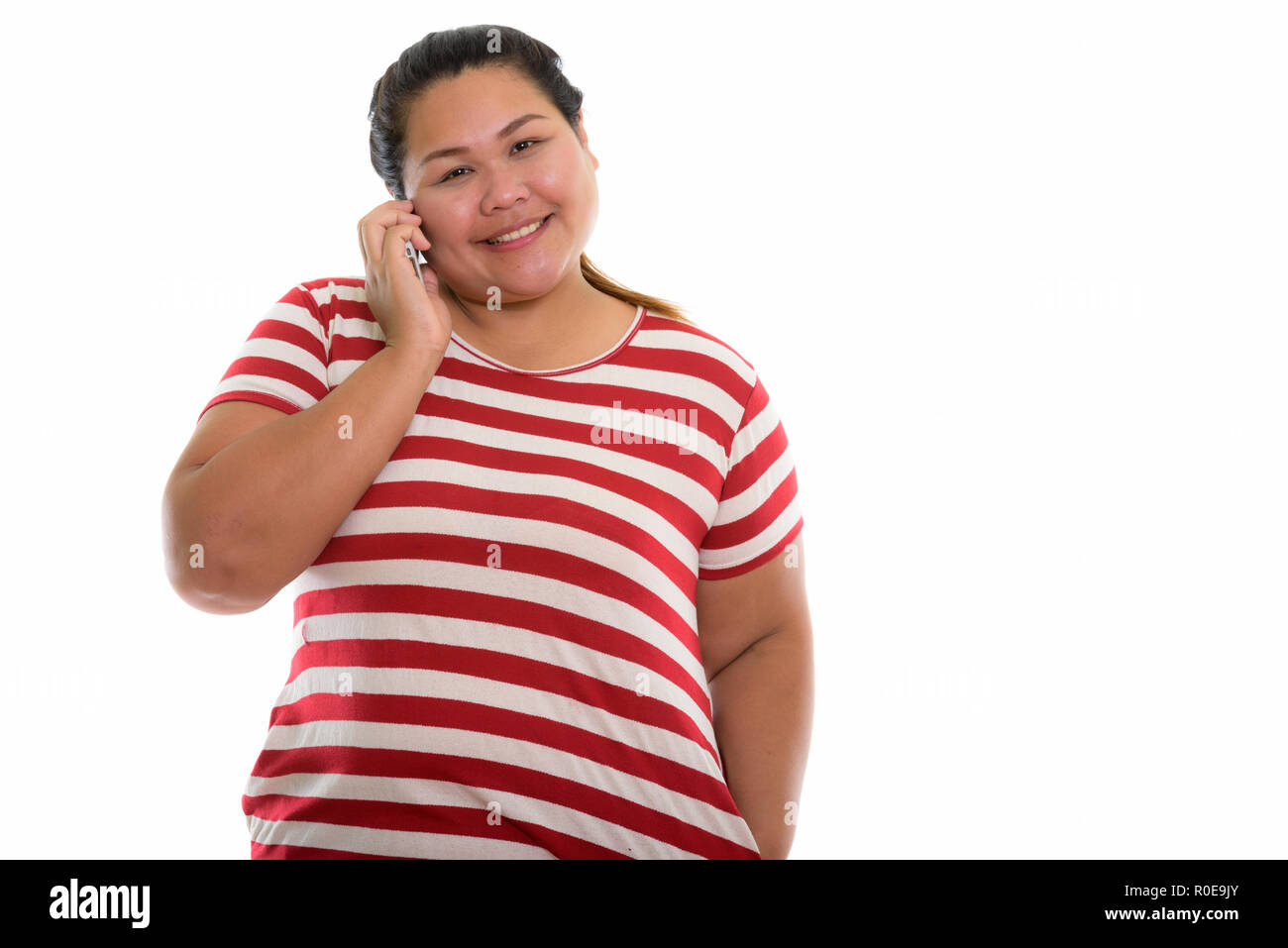 Studio shot der Jungen gerne Fett asiatische Frau lächelnd, während im Gespräch Stockfoto