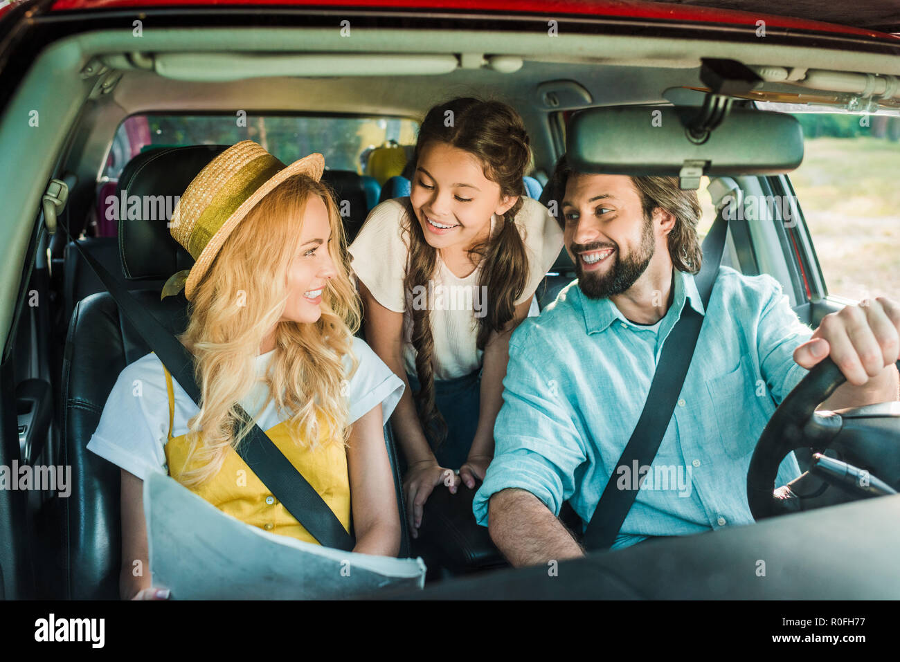 Lächelnd Eltern und Tochter mit dem Auto reisen mit Karte Stockfoto