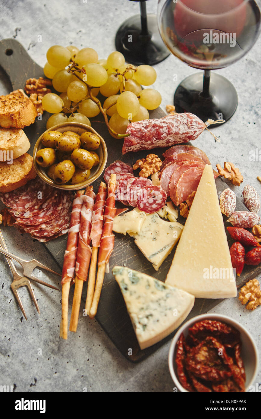 Kalte Snacks board mit Fleisch, Trauben, Wein, verschiedene Käsesorten Stockfotografie Alamy