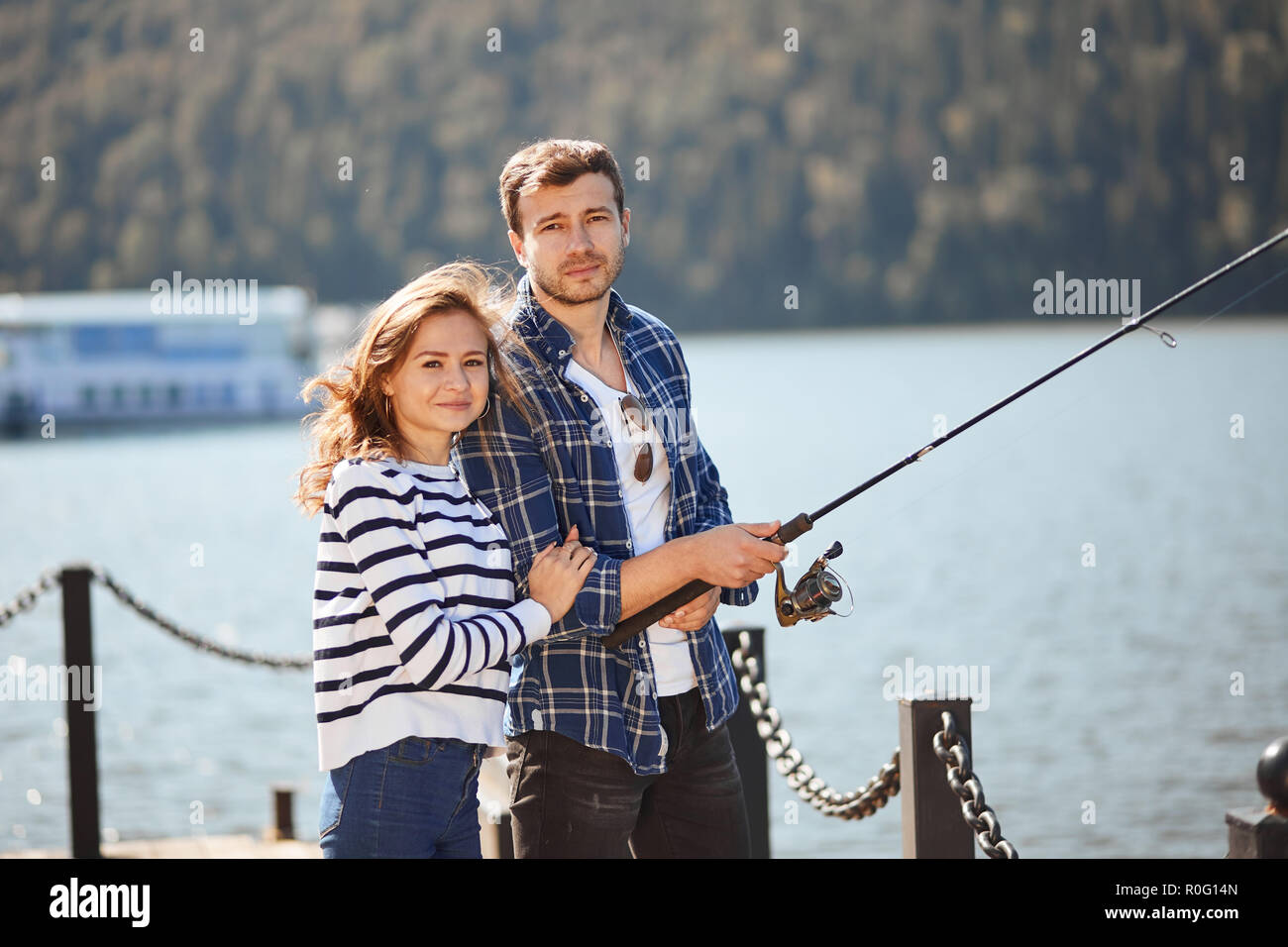 Ruhige junge Paar Angeln mit Teich im Herbst in See Stockfoto