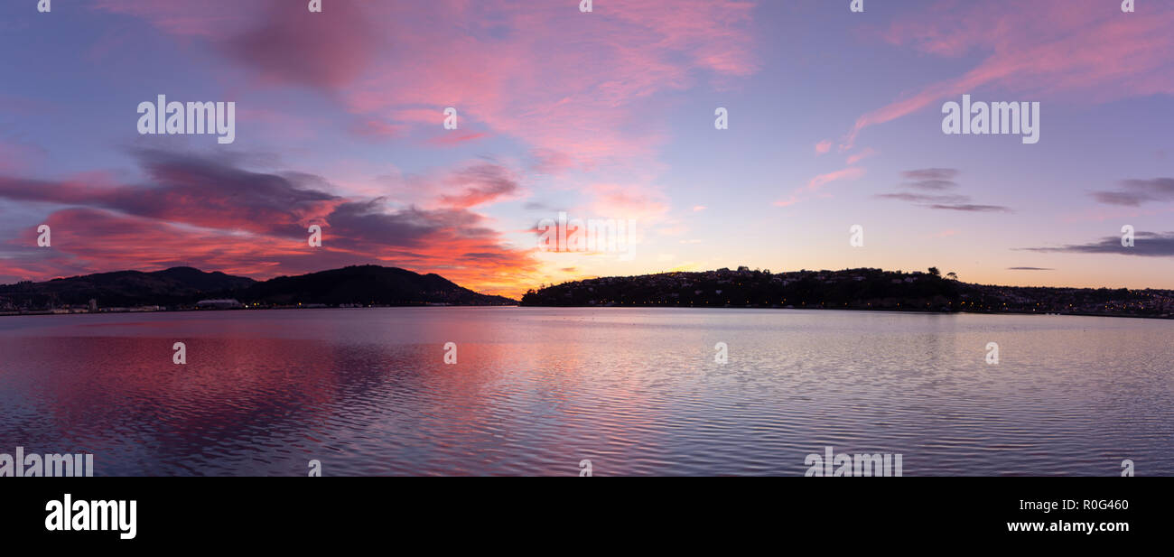 Am frühen Morgen Sonnenaufgänge wirft einen glorreichen pink Glow und Reflexionen über den Hafen Stockfoto