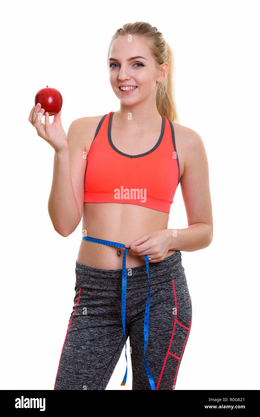 Junge happy teenage Mädchen lächelnd, während Sie red apple und Mea Stockfoto