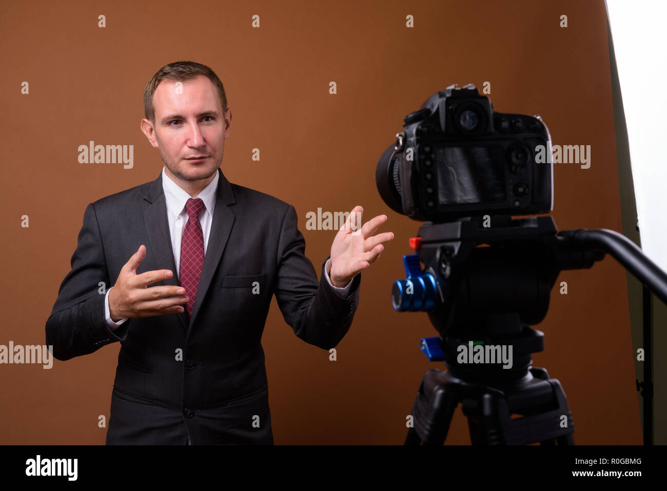 Studio shot der Geschäftsmann gegen braunen Hintergrund Stockfoto