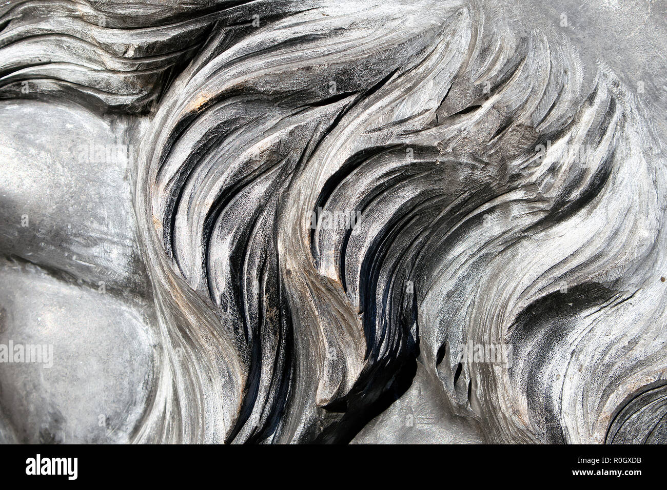 Grau wellenförmig Granit Löwen Mähne closeup, geschnitzten Stein Hintergrund oder Textur Stockfoto