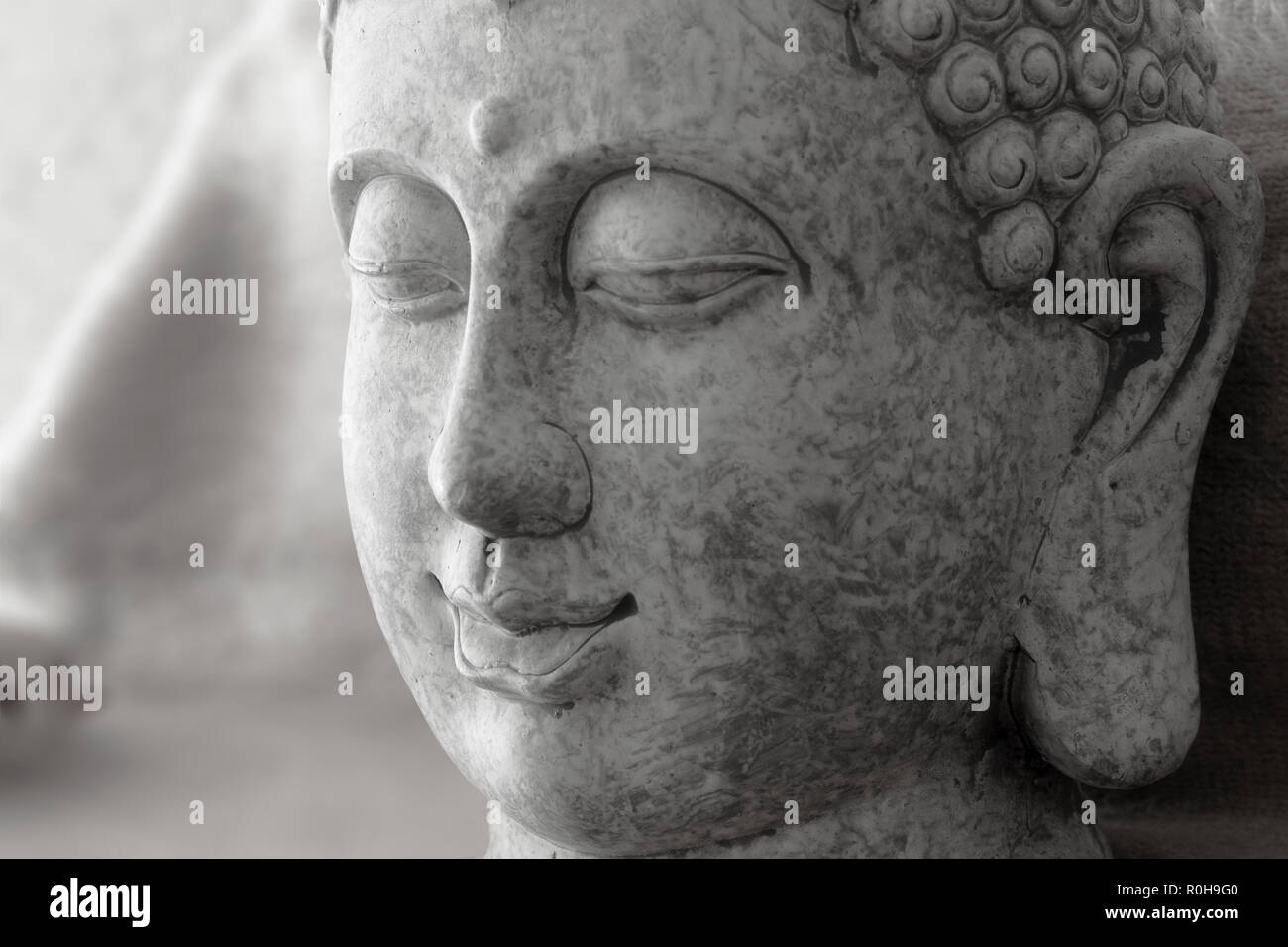 Makro Detail des Buddha Göttin Kopf auf Stein in grauer Farbe Stockfoto