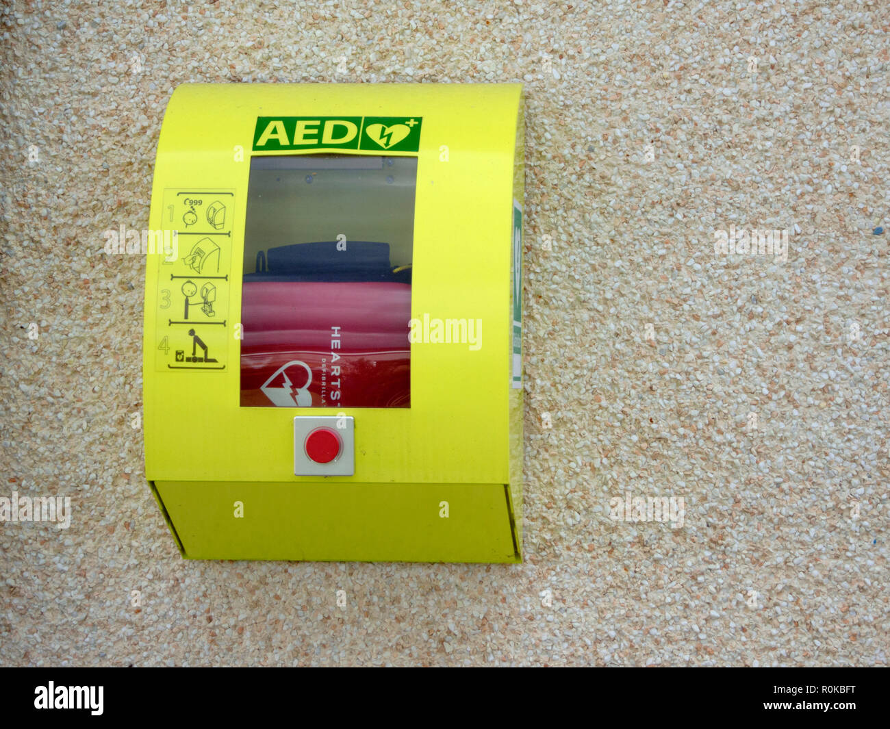 Defibrillator Medizinische Notfallausrüstung, montiert auf einem n Außenwand, Großbritannien Stockfoto
