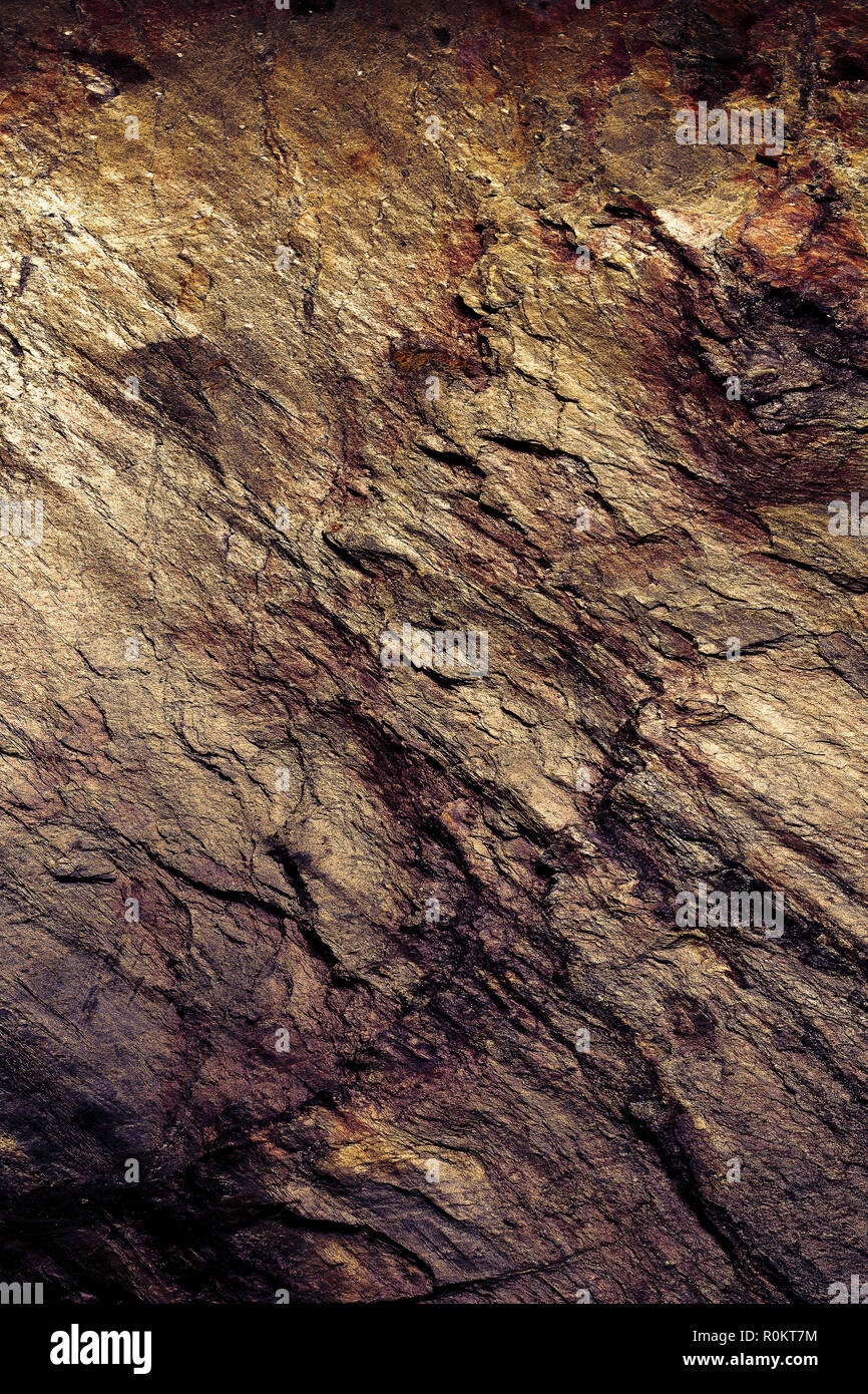 Stein Textur Hintergrund. Detaillierte natürliche Struktur in Nahaufnahme. Verhaltene herbstliche Farben in Gold und Rot Kupfer. Stockfoto