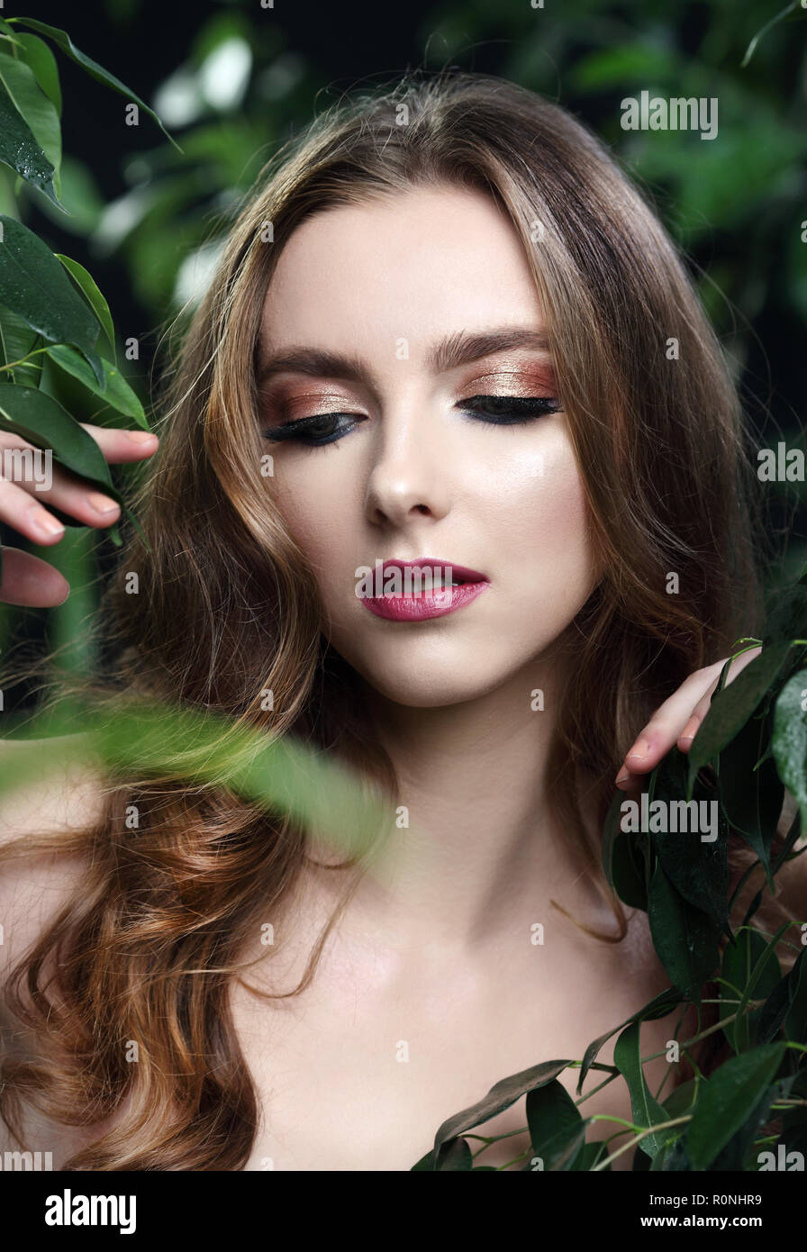 Junge attraktive Frau ohne Make-up mit einem frischen Grün Blatt posieren Stockfoto