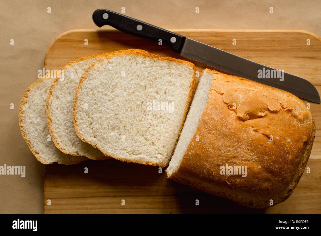 Geschnittenes Brot Brot und Messer auf Schneidebrett. Von oben nach unten anzeigen. Stockfoto