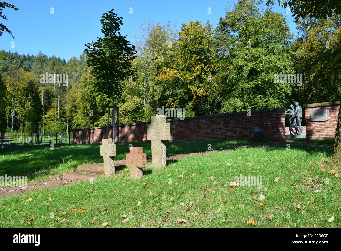 Blick auf den Sand Stein Kreuz am Eingang des Waldfriedhofes eines Deutschen Zweiten Weltkrieg Militärfriedhof in reimsbach an der Saar. Stockfoto