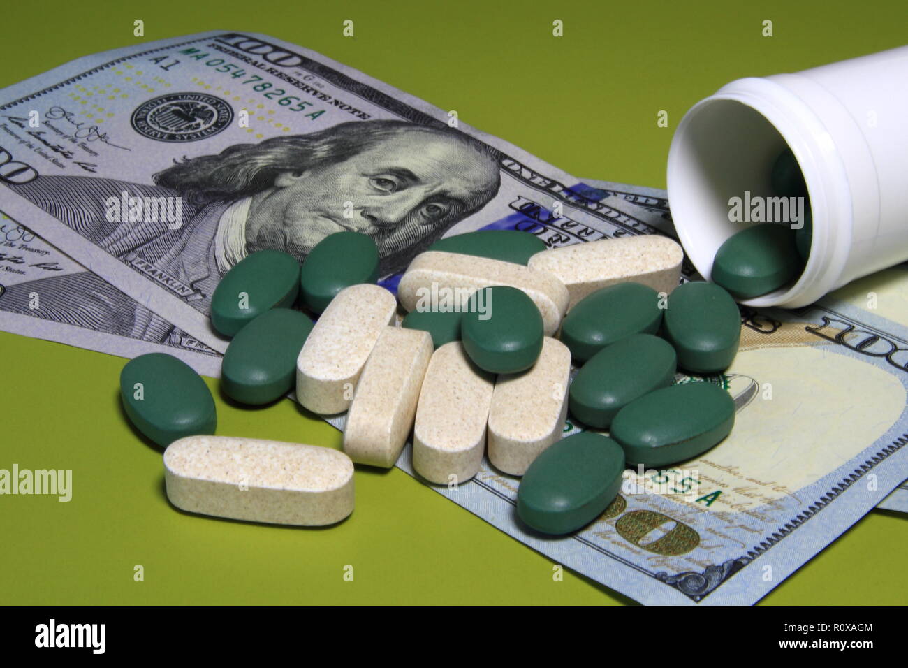 Medizin verschütten aus einem Paket auf die hundert Dollar Bill. Medical Business oder Preise Konzept. Stockfoto