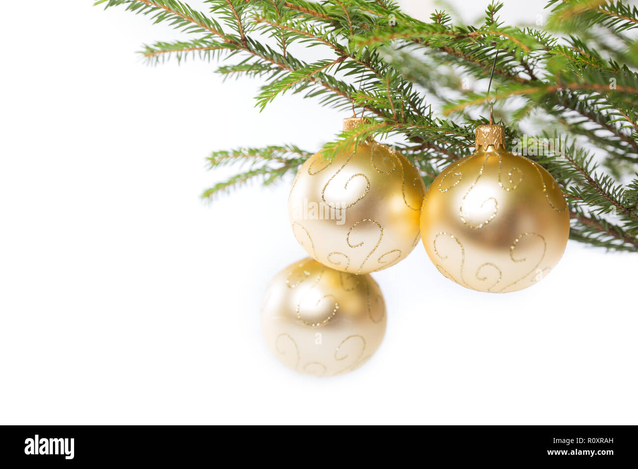 Weihnachtsschmuck, drei goldene Kugeln am Weihnachtsbaum auf weißem Hintergrund Stockfoto