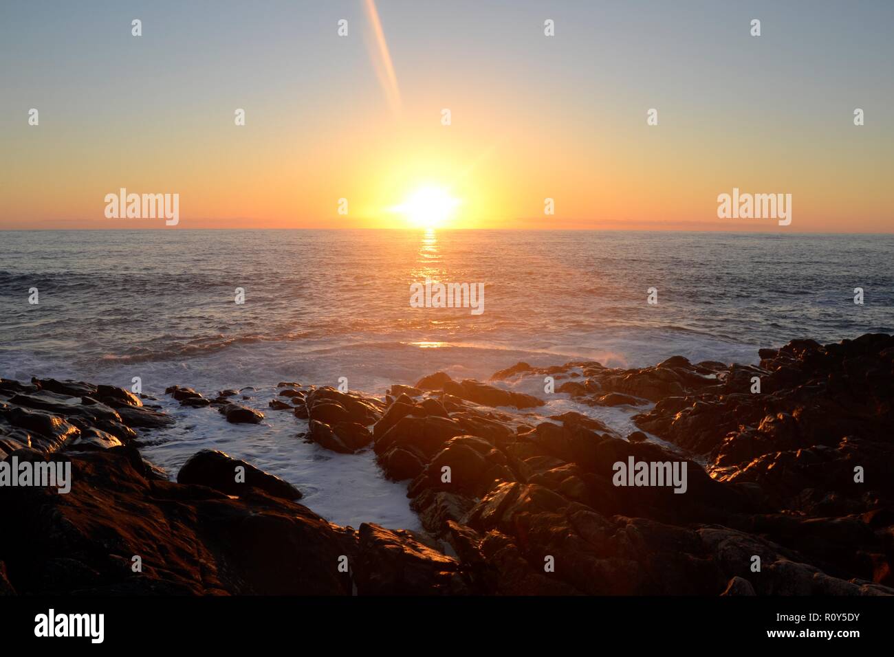 Sonnenuntergang auf dem Meer - Western Australia - Sonne, blauen Wasser, Felsen, Wellen und Orange. Stockfoto