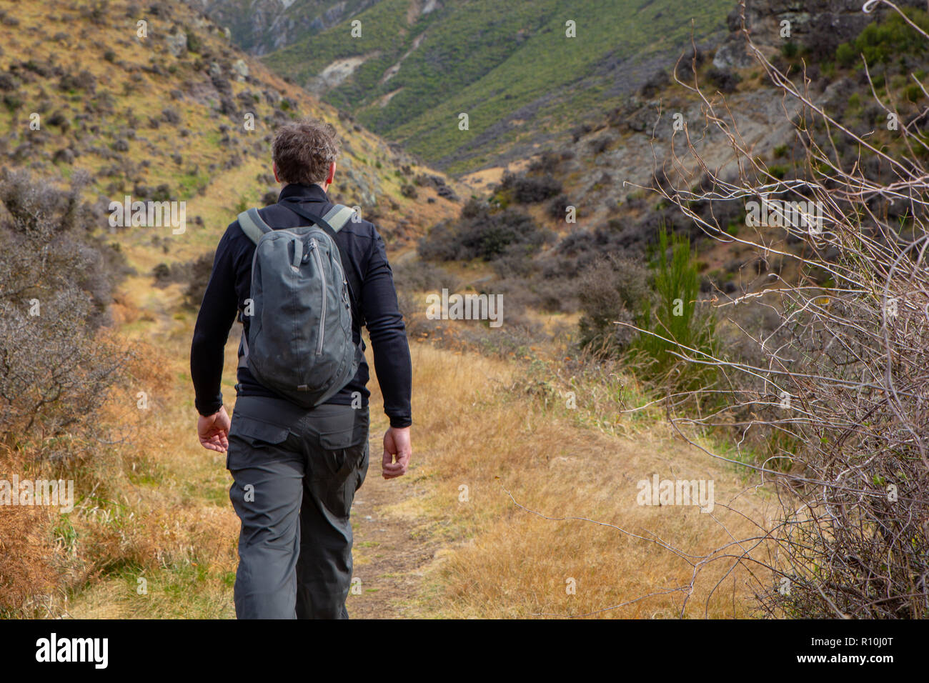 Ein Mann genießt einen gesunden Lebensstil Spaziergänge und Wanderungen in den Hügeln für Bewegung und Abenteuer Stockfoto