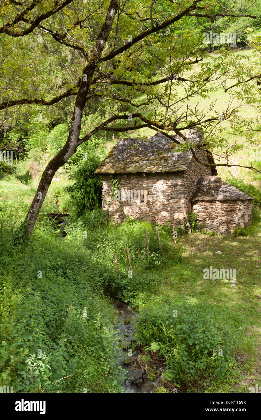 Old Stone Cabin und Stream in der unberührten Landschaft Stockfoto