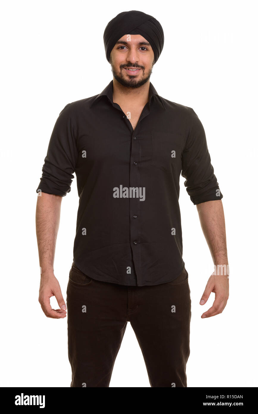 Porträt der jungen glücklich Indischen Sikh Mann mit Turban und lächelnd Stockfoto