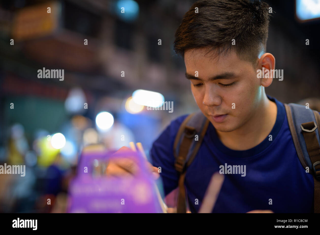 Junge Asiatische tourist Mann an Chinatown erkunden während Essen Nudelsuppe Stockfoto