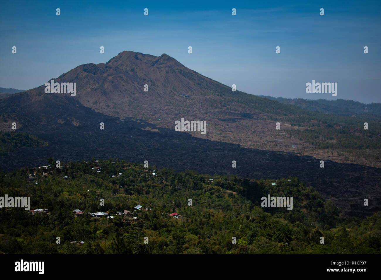 Vulkan, Berg bedeckt Wald, Himmel mit Wolken, Spuren von lava auf dem Boden. Mount Batur Vulkan in Kintamani. Berglandschaft, Bali. Travel Concept. Hintergründe Stockfoto