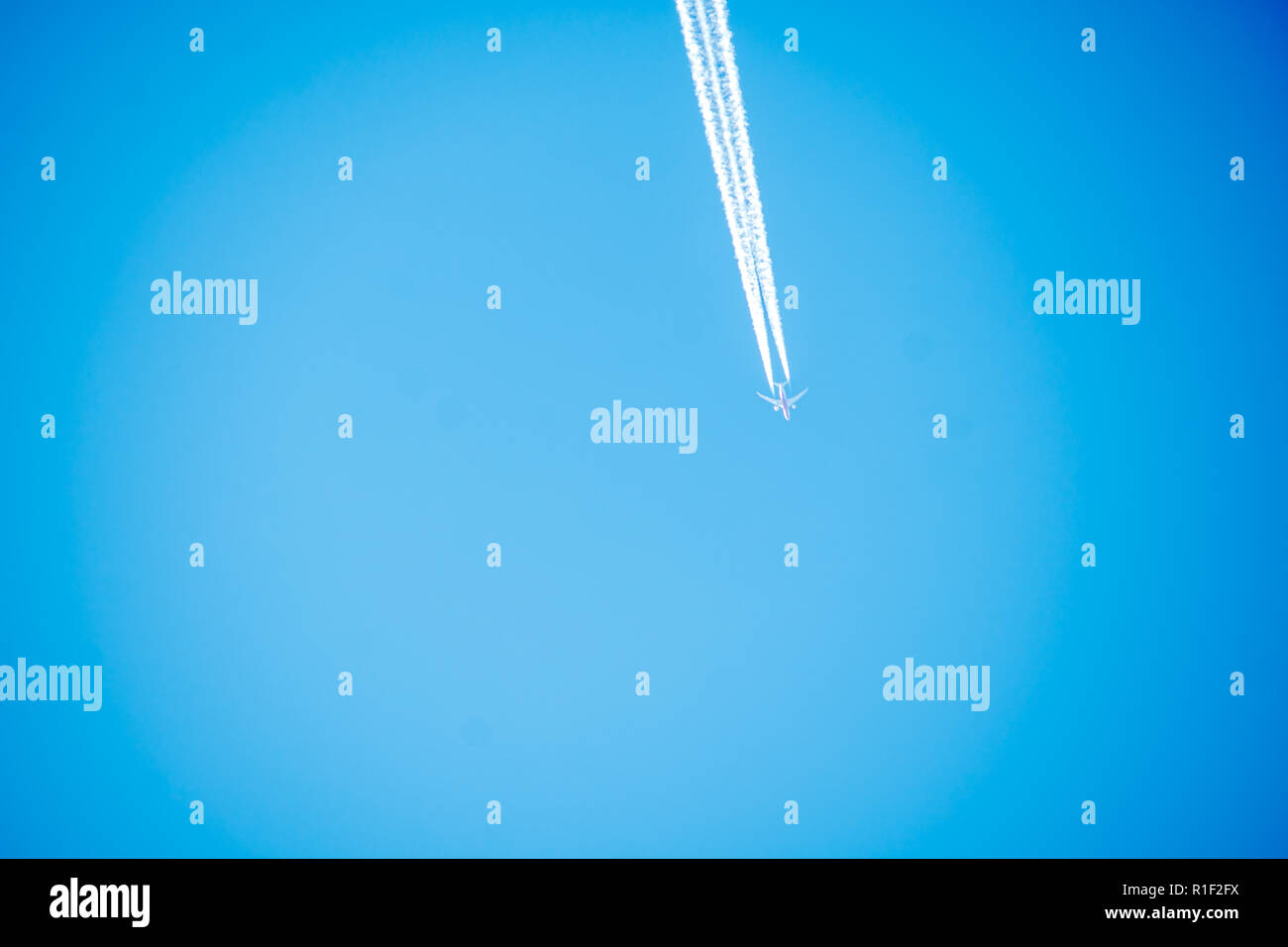 Flugzeug Kondensstreifen gegen feste klaren blauen Himmel. Stockfoto