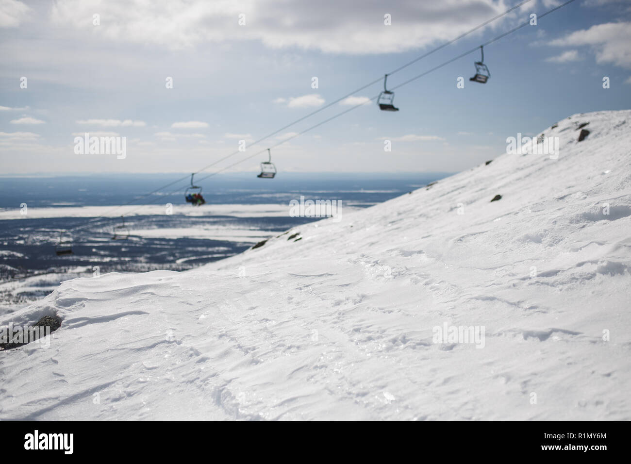 Glänzend Schnee mit unscharfen Ski-lift Cable Car und Gebirge. Kopieren Sie Platz. Stockfoto