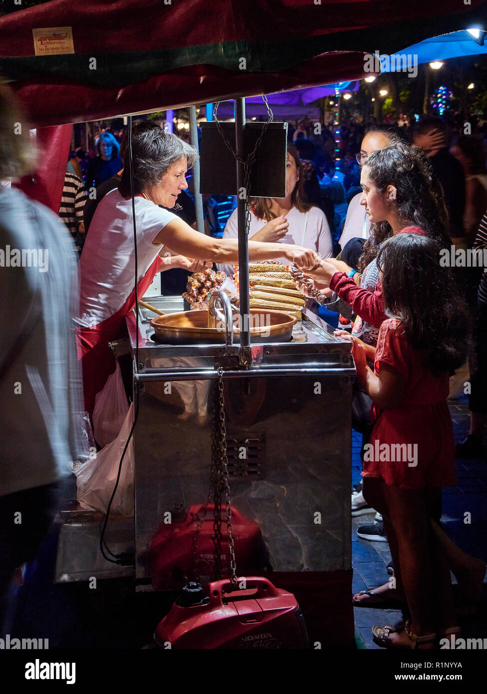 Ein Koch und Verkauf von kandierten Mandeln, in einem Stall eines Europäischen Messe. Stockfoto