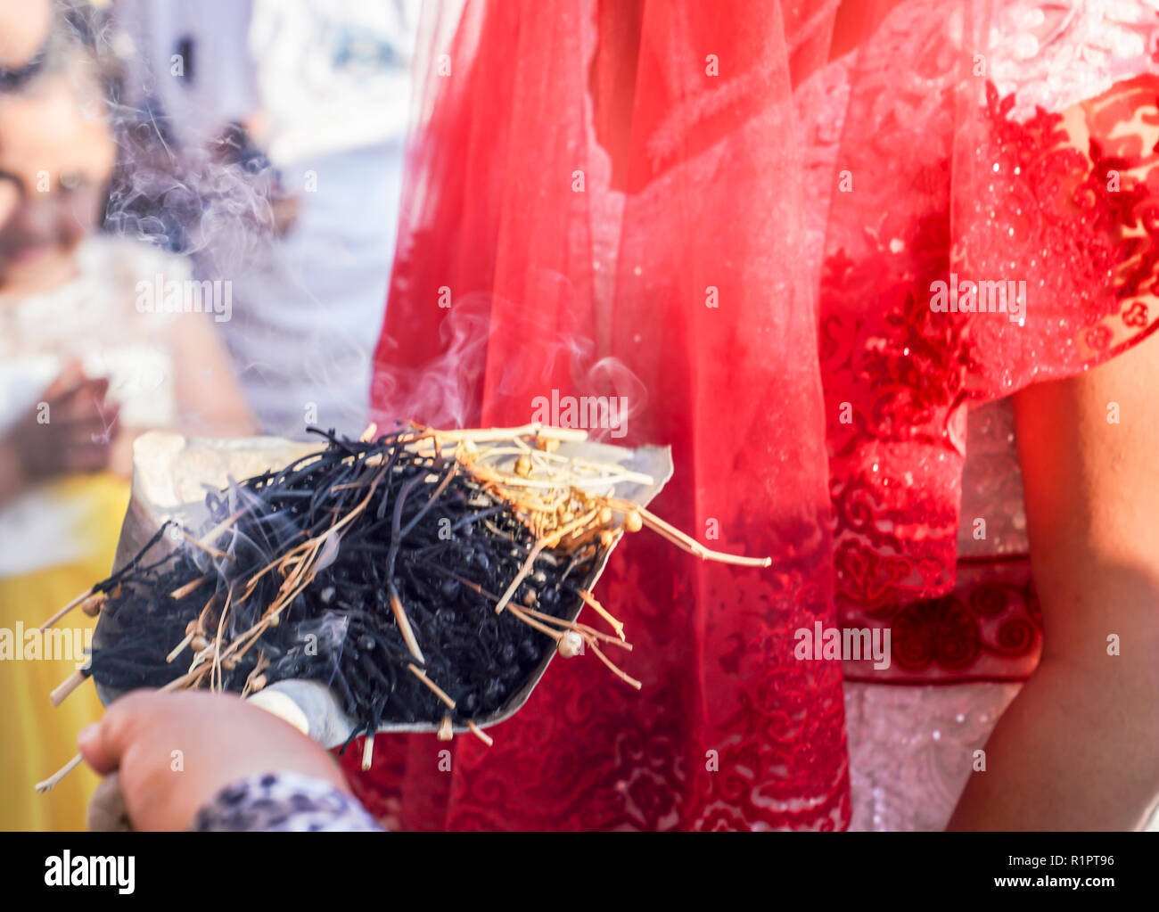 Schamanische Tradition für viel Glück in der ländlichen Türkei. Räucherstäbchen von Kraut sticks raucht geht an junge Paare in einer Hochzeitszeremonie. Stockfoto