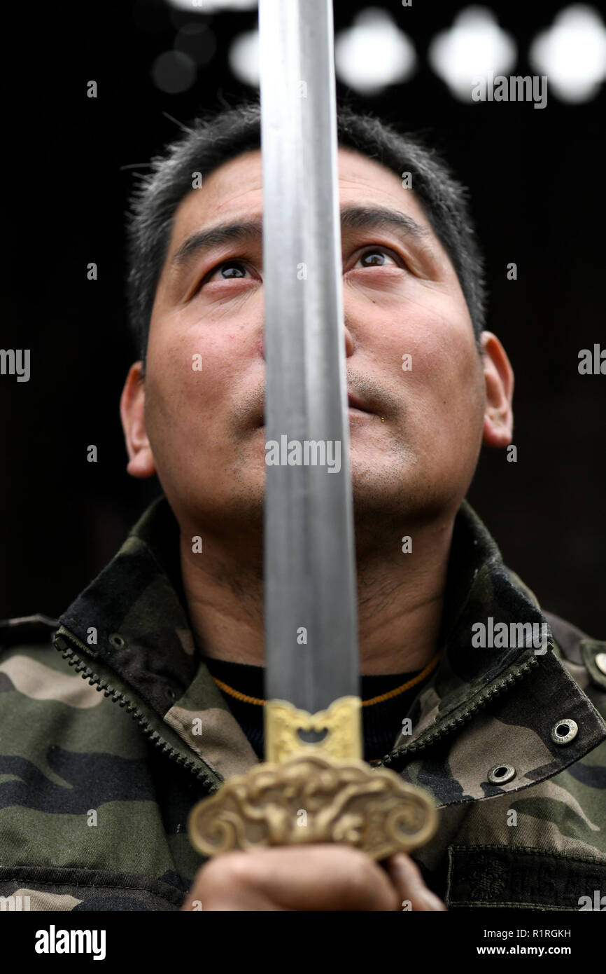 (181114) - SHIJIAZHUANG, November 14, 2018 (Xinhua) - Li Zhujun prüft ein dekoratives Schwert in seinem Studio in Tiejiangzhuang Dorf Xingtang County, Shijiazhuang, nördlich der chinesischen Provinz Hebei, Nov. 14, 2018. Für Jahrhunderte, Tiejiangzhuang Dorf wurde für seine geschickte Schmiede und wohlhabenden Stahl Industrie bekannt. Li Zhujun ist eins der wichtigsten Stahlproduzenten des Dorfes. Auf der Grundlage der Fähigkeiten von seinem Vater geerbt, Li gewann eine Expertise in der Stahl-machen Technik sind verurteilt Muster Schweißen', fügt hinzu, die komplizierte Muster der Schwerter und Messer beim Schmieden. Die Technik Stockfoto