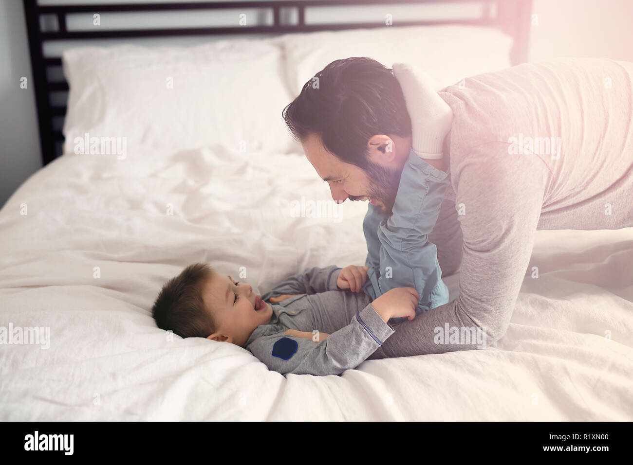 Vater und Sohn im Bett, glückliche Zeit auf dem Bett Stockfoto