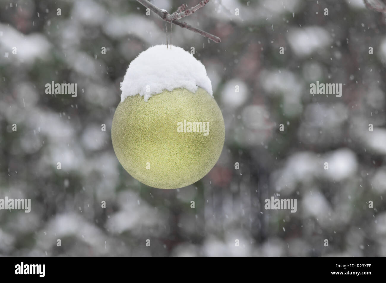 Gelbe Christmas Ball ausserhalb von Schnee bedeckt. Außerhalb der schneereiche Winter Szene mit Weihnachten Dekoration Stockfoto