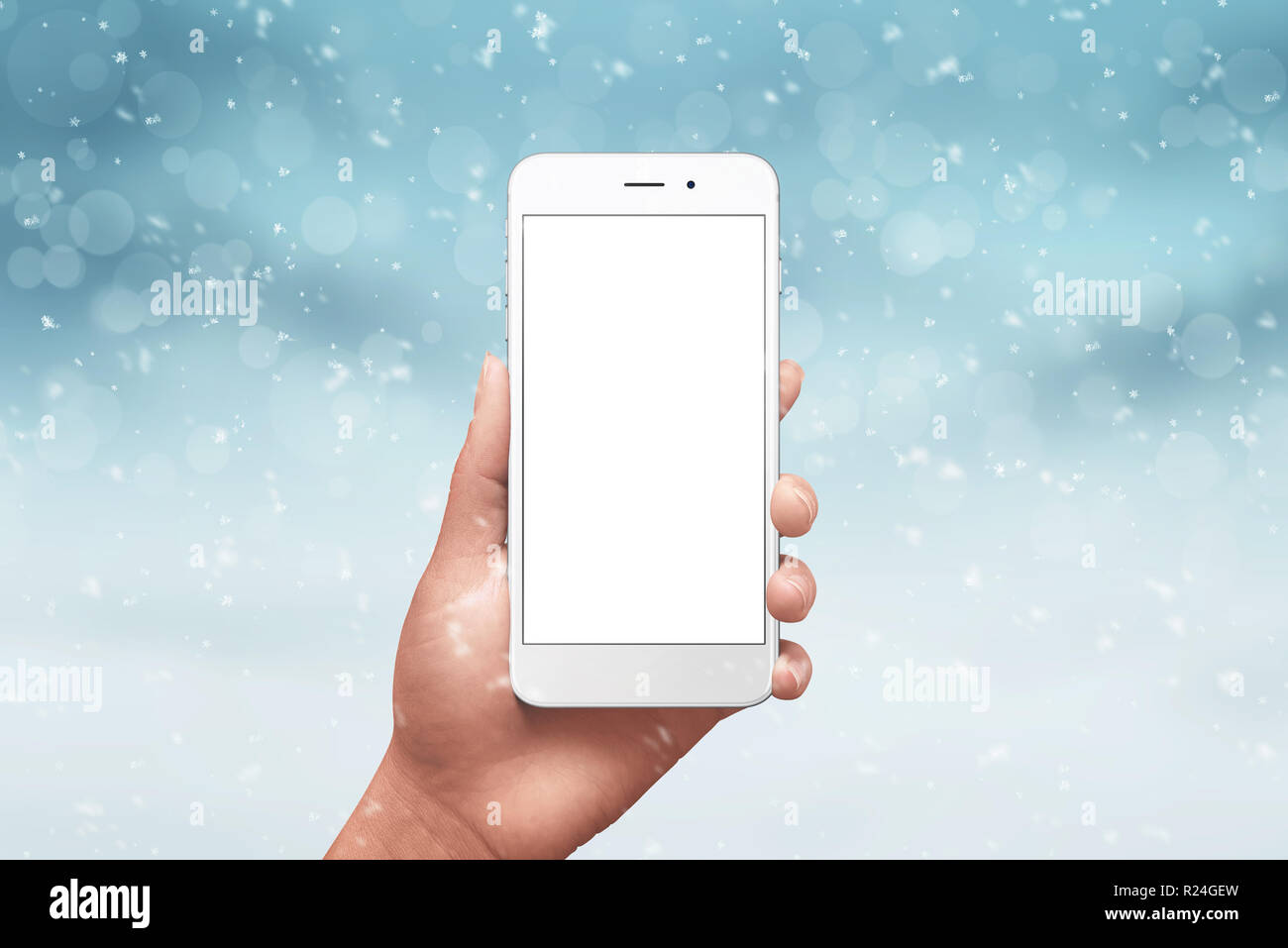 Telefon Mockup in der Hand umgeben mit Winter