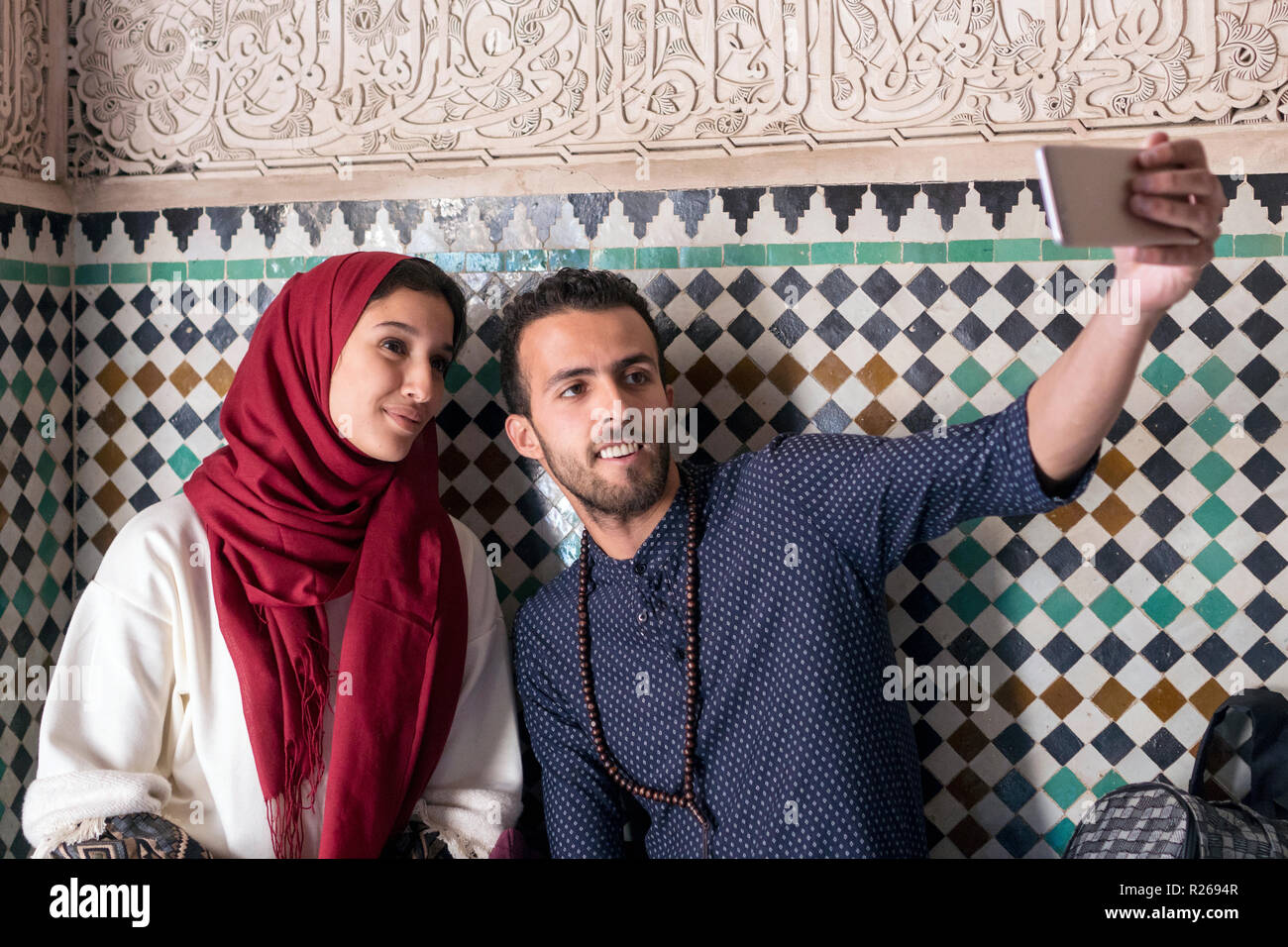 Junge muslimische Paar lächelnd und unter selfie mit smart phone Stockfoto