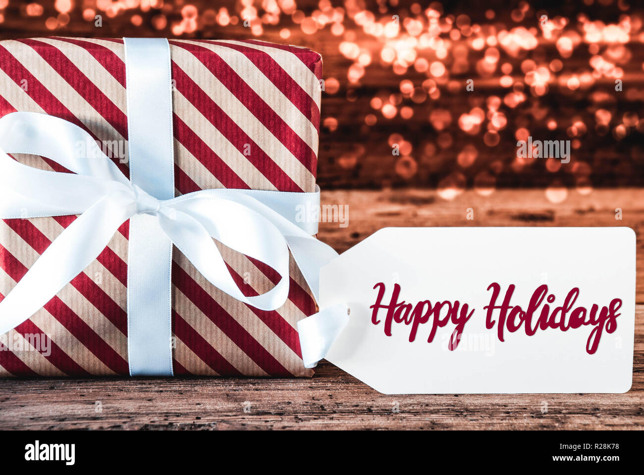 Ein Weihnachtsgeschenk, Kalligraphie Happy Holidays, Bokeh Stockfoto