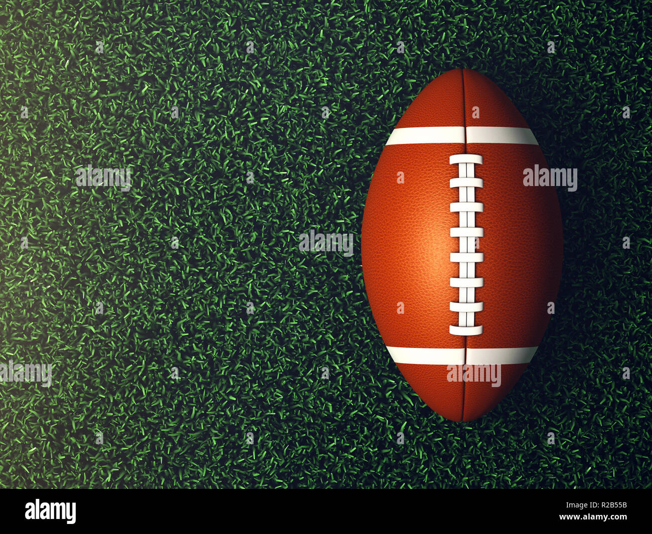 American football Ball auf Gras leuchtet von Spotlight von oben gesehen, Sport Arena Stockfoto