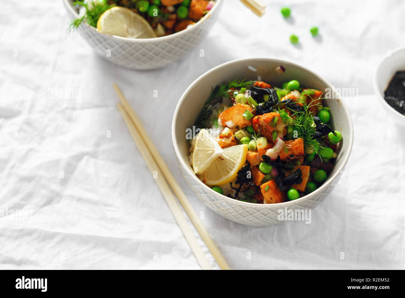 Vegetarische zwei poke Schalen. Tofu, Reis, Seetang, grüne Erbsen und Zwiebeln leckere und gesunde vegetarische Kost Stockfoto