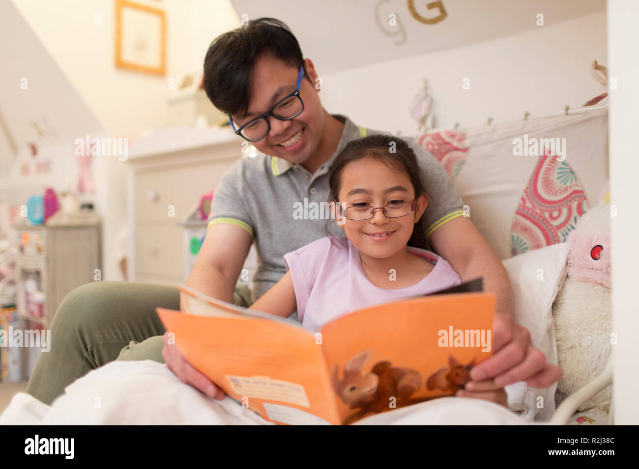 Vater und Tochter Lesebuch im Schlafzimmer Stockfoto