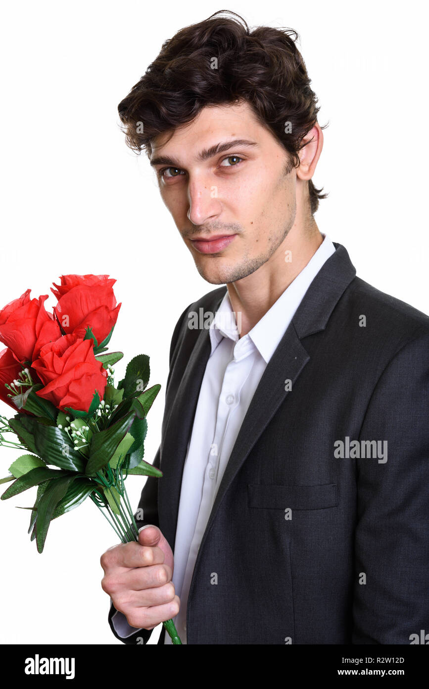 Studio shot von jungen hübschen Geschäftsmann mit roten Rosen Stockfoto