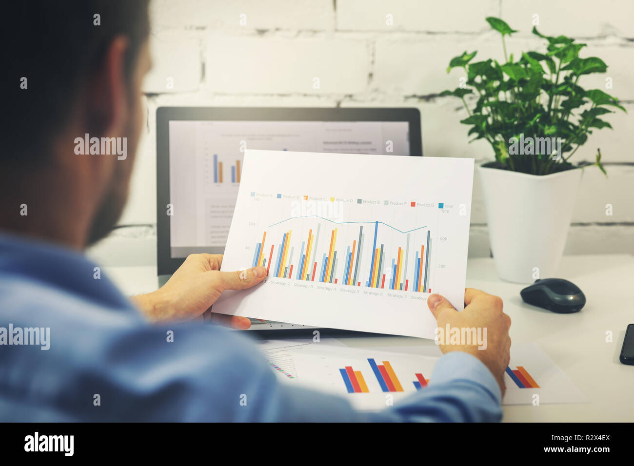 Mann bei der Arbeit mit Business Statistiken Daten in Office Stockfoto