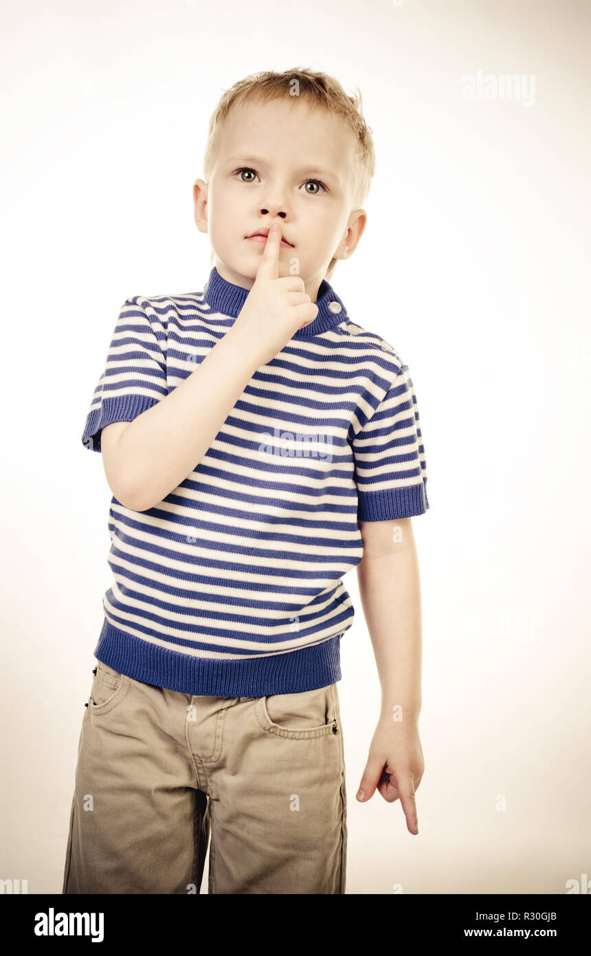 Kleine Junge mit Finger auf seinen Mund Stockfoto