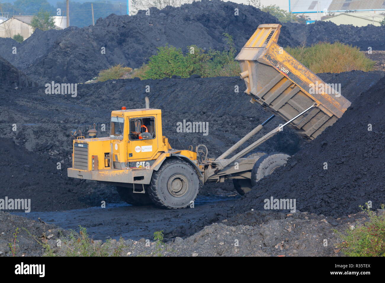 Ein Caterpillar 400D auf dem alten Recycoal Kohle Recyclinganlage in Rossington, Doncaster, der jetzt abgerissen wurde, um Platz für neue Häuser zu machen. Stockfoto