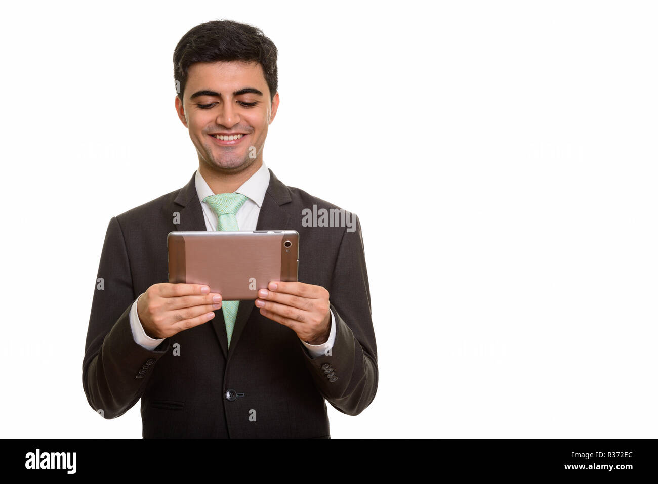 Junge glücklich Persischen Kaufmanns Holding digital Tablet Stockfoto